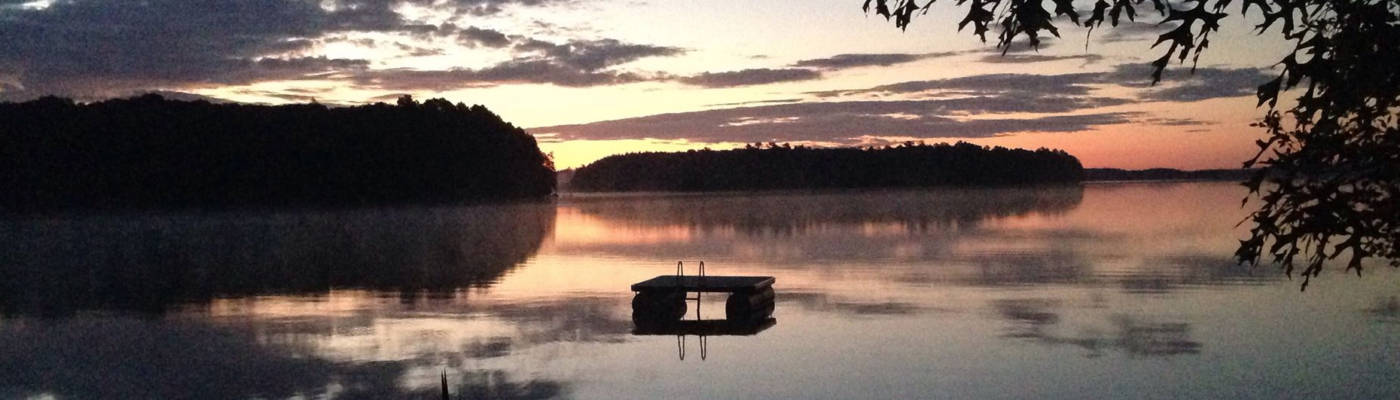 sunset on lake with diving platform